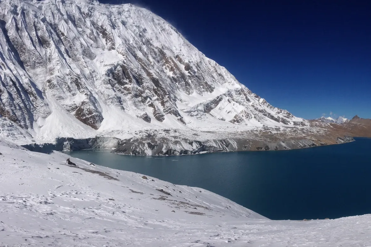 Tilicho Lake beneath snow-covered peaks in the Annapurna region of Nepal