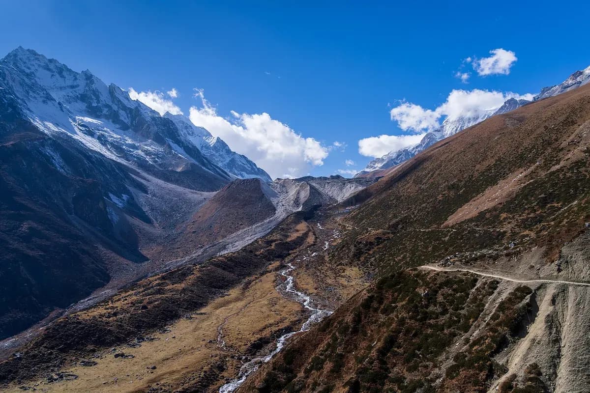 A trail crossing open slopes on the approach towards Dharamsala and Larkya La