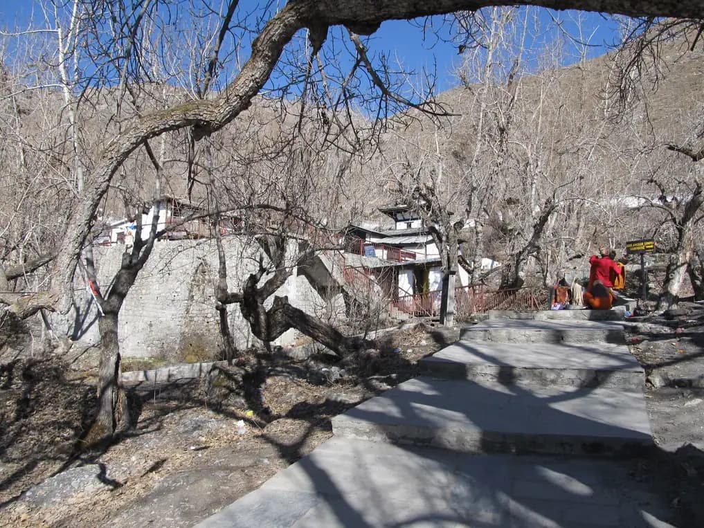 Stone path and bare orchards at Muktinath before the return to Jomsom.