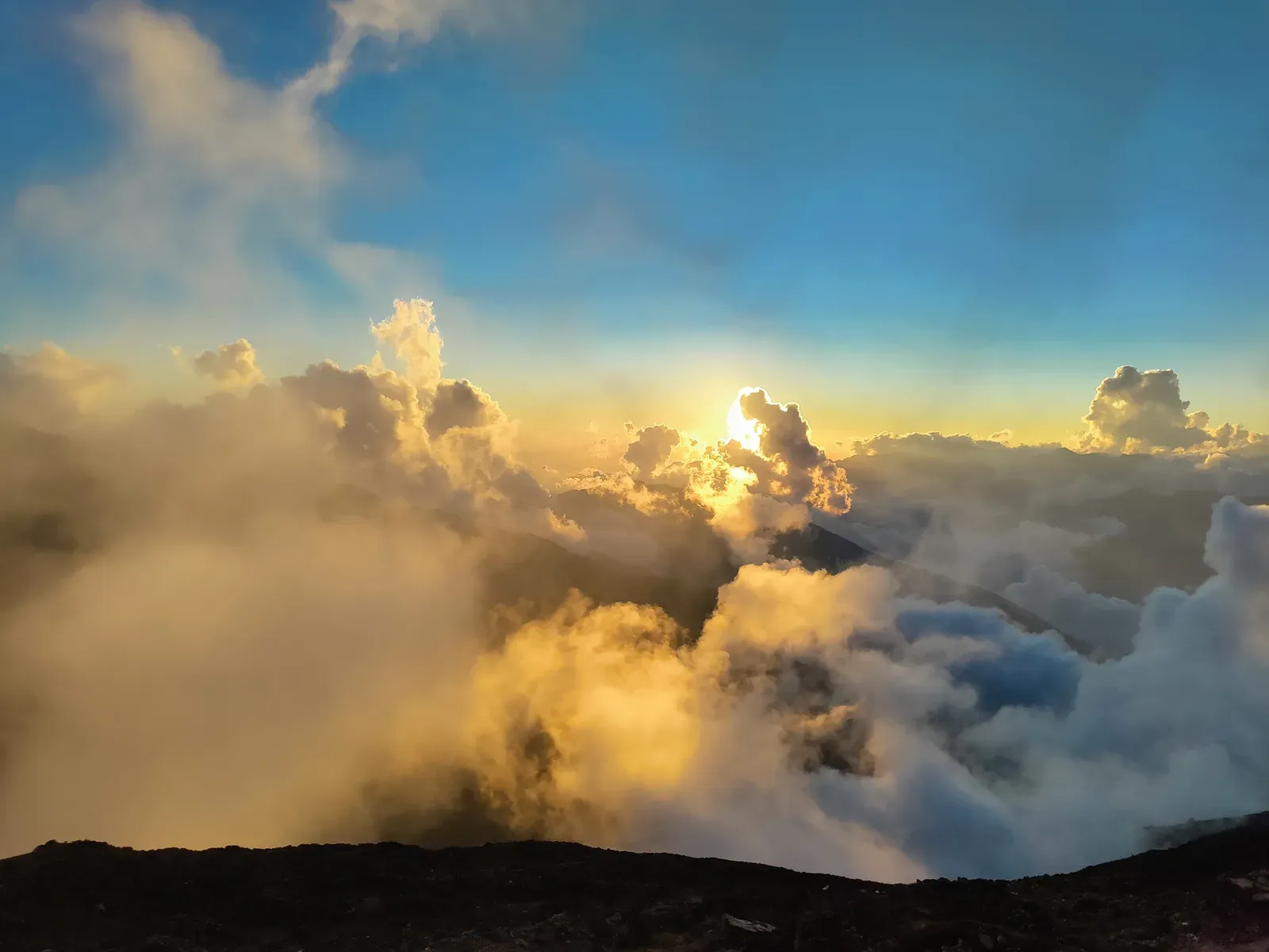Golden sunlight breaking through clouds above a high ridge in the Langtang and Gosaikunda region.
