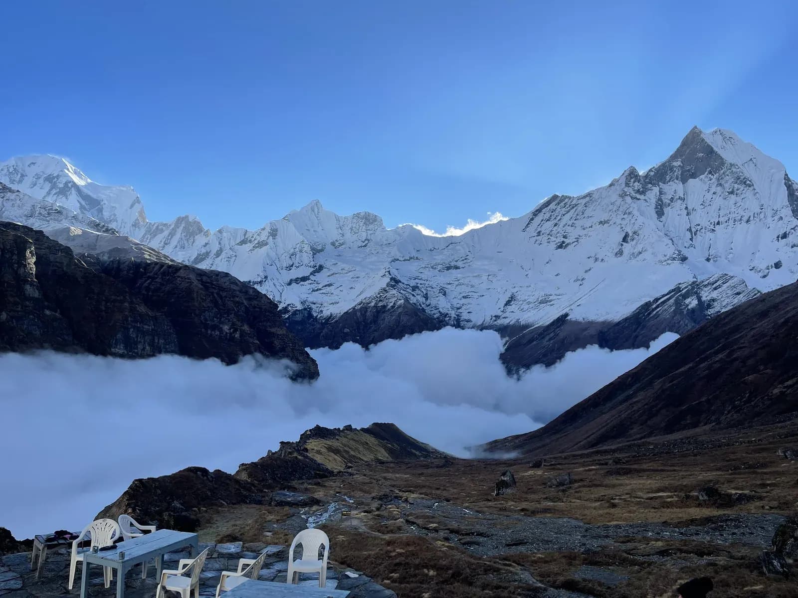 The snow-covered Annapurna Sanctuary rising above a bank of cloud.